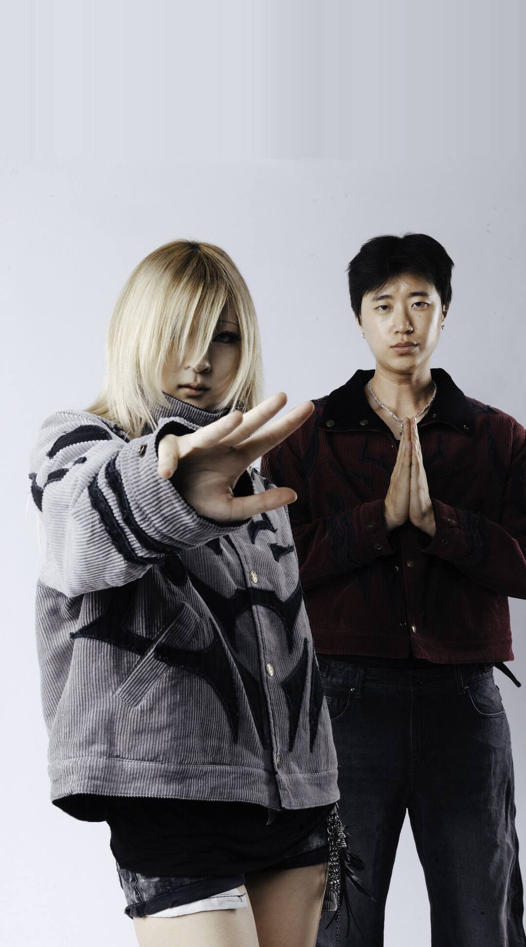 The JJK jackets on two models against a steel shutter